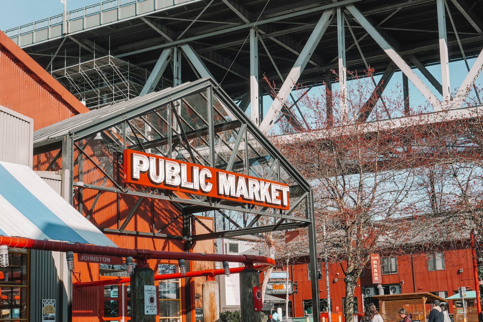 The red Public Market sign at Granville Island beneath the Granville Street Bridge